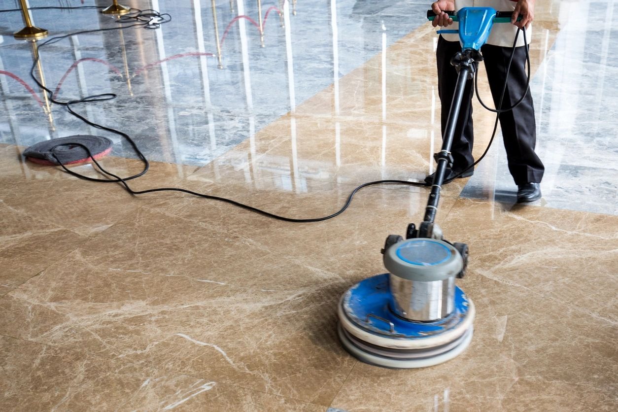 A person is cleaning the floor with a machine.