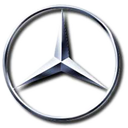 A silver mercedes logo in the middle of a circle.